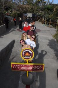Just a couple of tourists standing on the equator.