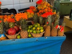 Fresh fruit like pineapples and citrus on display.