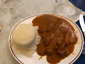 Rice and meat with sauce.