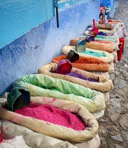 Chefchauen, Morocco street market selling different colored beans and rice.