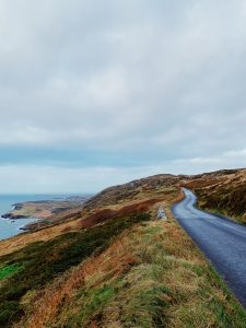 Roads across the moors in Ireland next to the ocean.