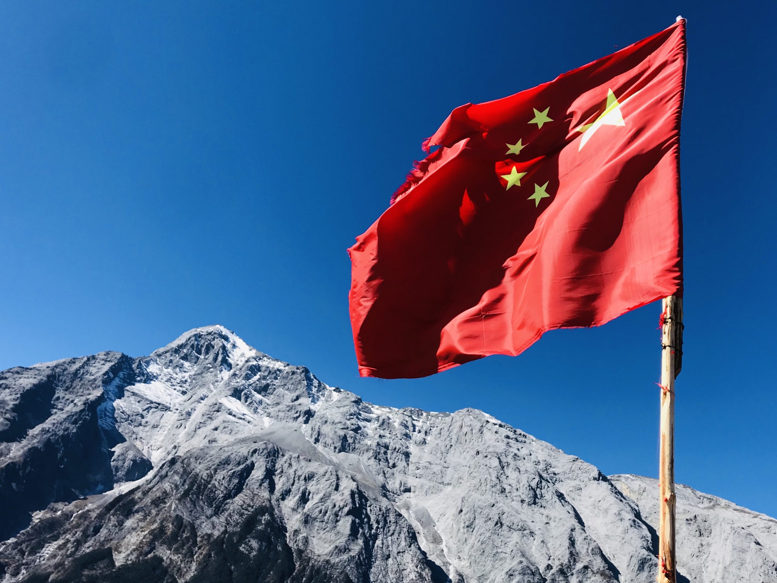 Chinese Flag on the top of Jade Dragon Mountain in Lijiang