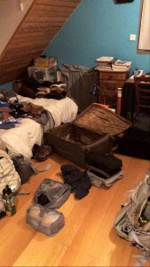 Belongings from a suitcase in a small room.