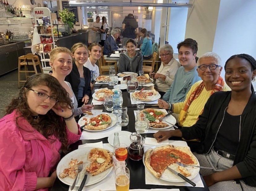 9 people eating pizza