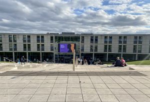 Modern building with stone stairs leading down to the entrance.