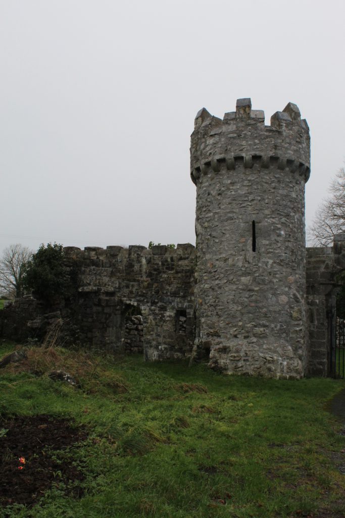 Old castle entrance showcasing old stone turret and moss covered stone