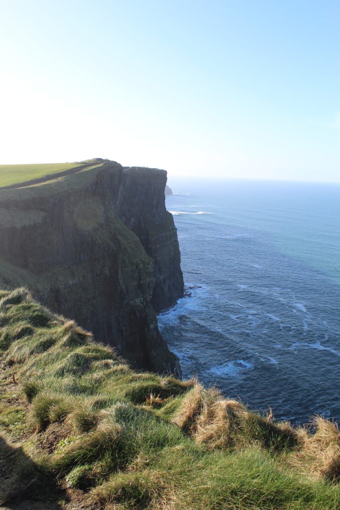 Cliff's of Moher, blue sky, and blue ocean.