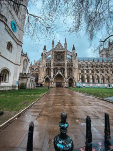 Wet Westminster Abbey Cathedral with blue cloudy skies. 