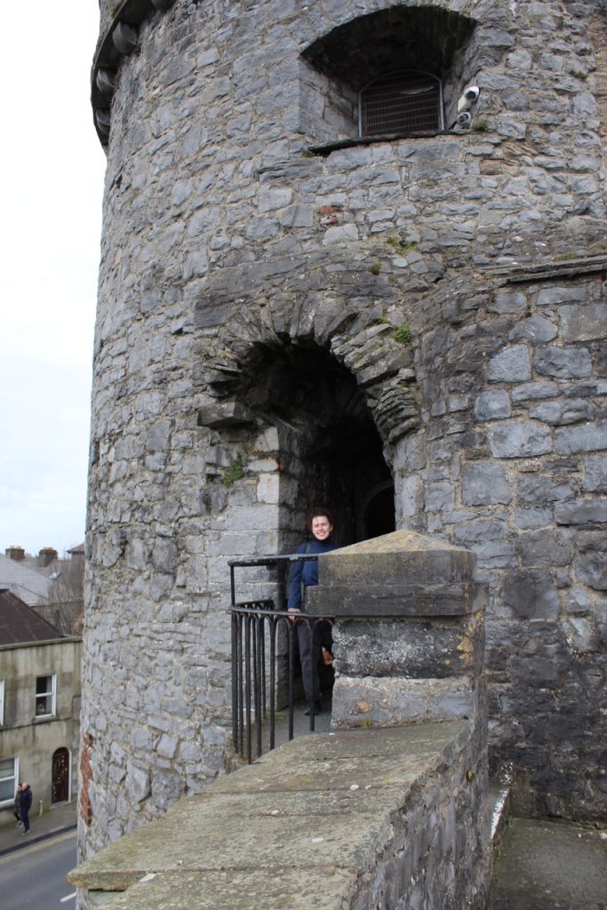 Archway and turret of King John's castle with girl standing in the archway