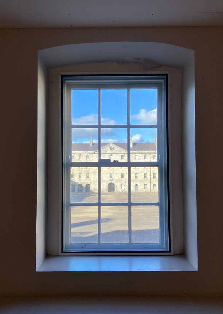 window overlooking a courtyard with art building viewed through it