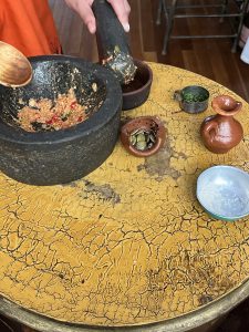 picture of ingredients and a molcajete used for making a spicy salsa