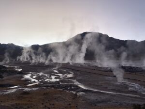 Sun rising and the landscape of geysers