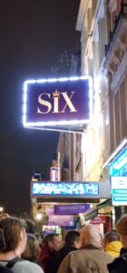 A simple marquee, the decoration for Six is minimal, with a simple sign in royal purple adorned in white lights and the logo on either side.