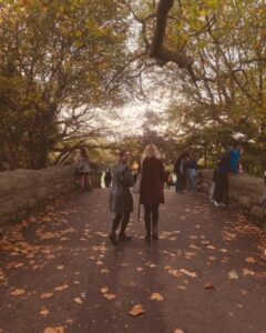 Two young ladies walking over the bridge leading into the heart of St Stephen's Green in the city center of Dublin