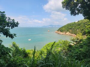 View from Cheung Chau, an island my friends and I visited earlier in the semester, over the water, clear blue sky, and beautiful green trees and bushes. 