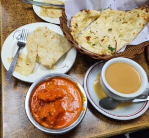 The delicious dinner I got at the Indian restaurant we went to. I got garlic naan, milk tea, butter chicken, and paratha. 