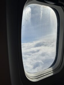 plane window with clouds outside.