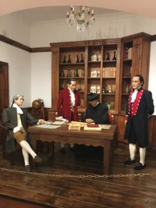 Pictured are wax figures depicting the early history of Ecuador's fight towards independence. Here, there are four wax figured men in an office thinking about their next strategical move