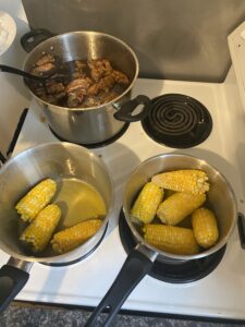 Cooking food including shoyu chicken and sweet corn
