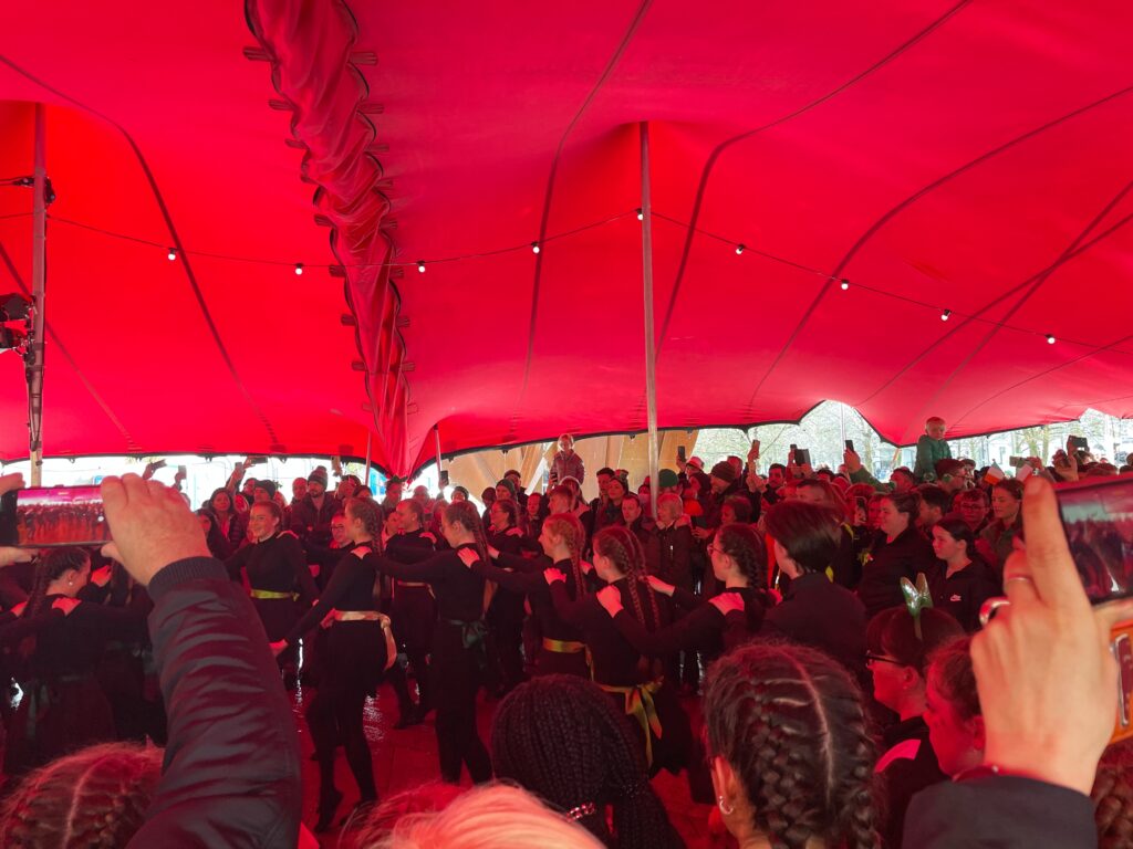 dancers under a red tent