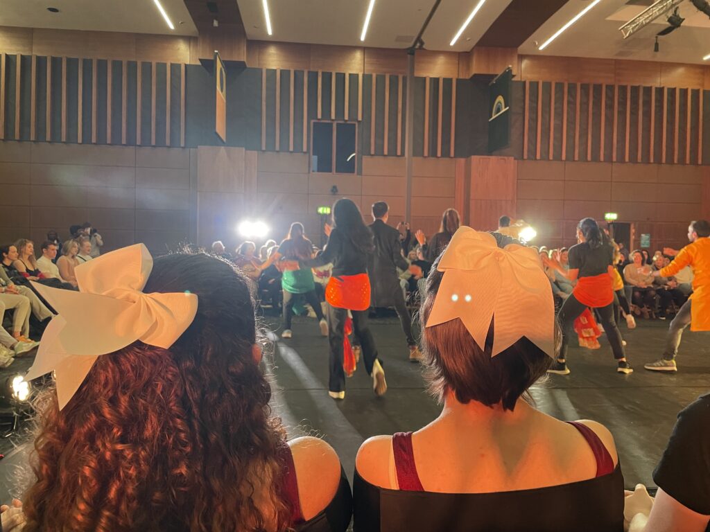 a group of dancers dancing to Bollywood music