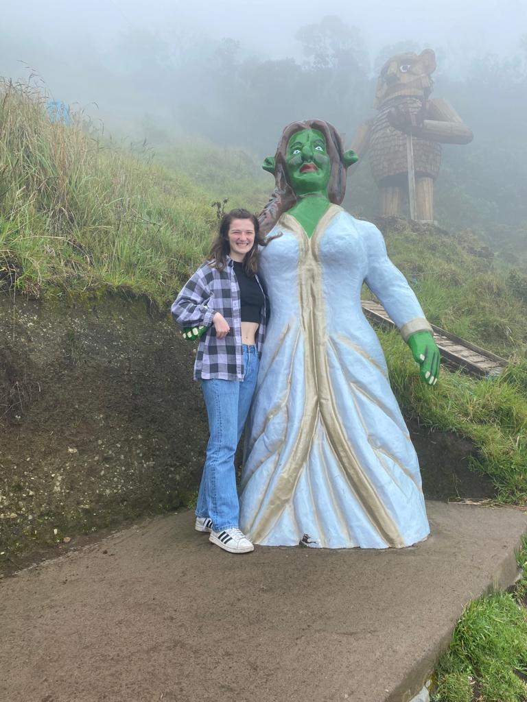 Pictured is me with a giant structure of Fiona from Shrek. In the photo, we both have our arms around each other posing for the camera.