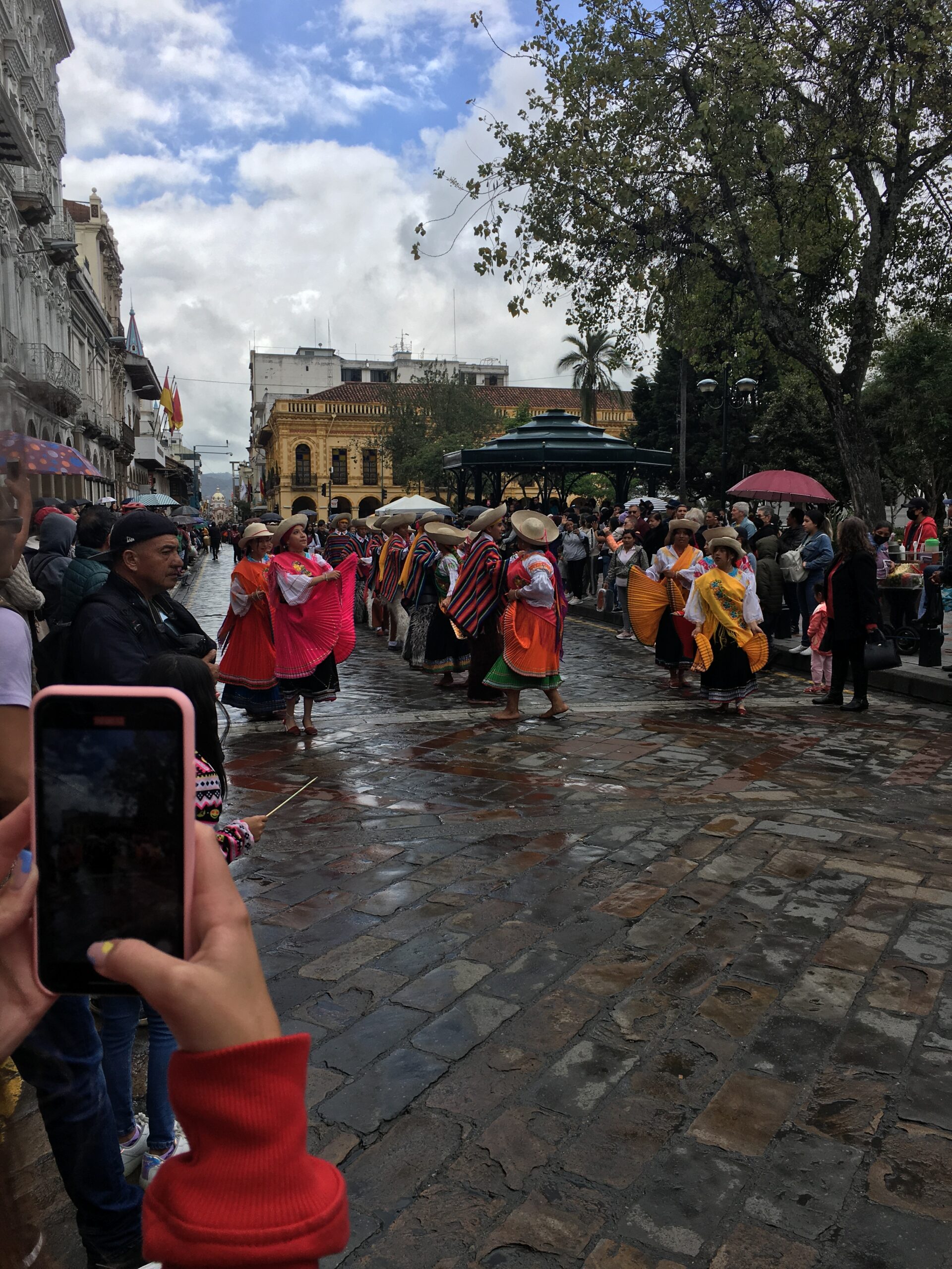 Pictured here is a parade in Cuenca. The dancers pictured are wearing traditional clothing and dancing traditionally down the streets of Cuenca. 