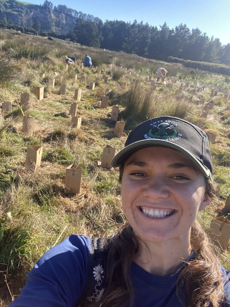 Kahiau taking a selfie with the planted seedlings