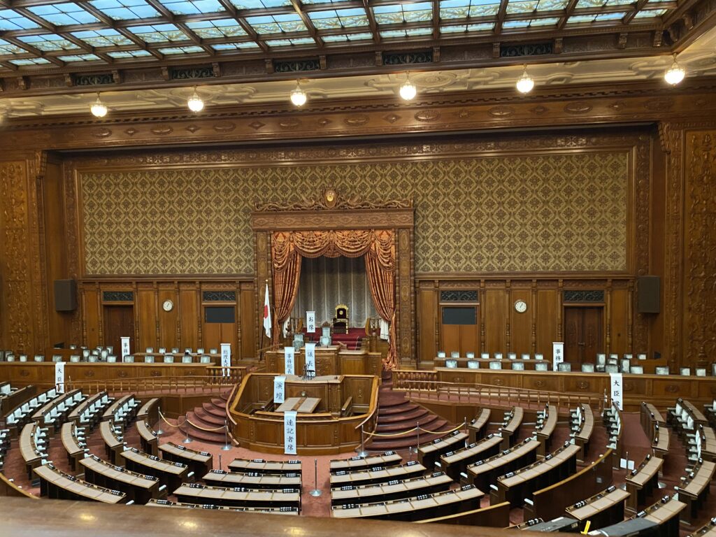 In the center, there is a raised area for the main officials. Facing opposite of the central stage, following its curve are rows of desks where the representatives would be seated. This is the room that is typically seen in the news pertaining Japanese politics.