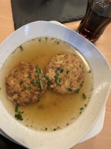 A picture of frittatensuppe (a beef broth based soup with savory dumplings)