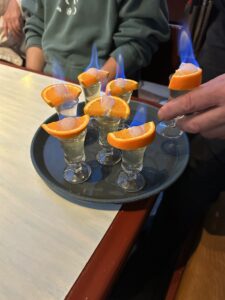 A photo of orange schnapps (on fire) presented to the Linfield gang as a gift after our dinner of Käsespätzle at a local Dorfgastein restaurant. 