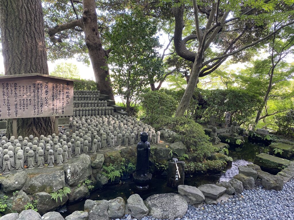 More of the small Jizo statues. There is a small stream of water with a slightly bigger Jizo standing within it. It is called the Mizukake Jizo and one can gently pour water over it. 