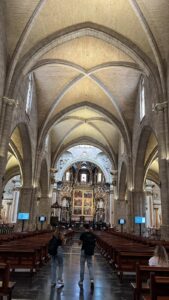 The interior of the historic church in Valencia, Spain, with its' tall, vaulted ceiling and beautiful windows.