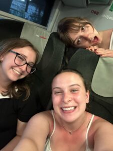 A photo of Sage, Lizzie, and Rachel on the train to Budapest with no idea what they will be doing once they get there. Only pure (and maybe naive) joy is present on their faces. 