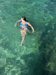 A photo of Lizzie floating in the Ionian Sea, feeling at peace and enjoying life. 