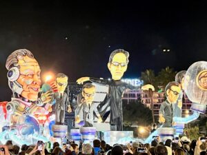 Float from the parade of lights. The theme is the Matrix but Elon Musk is hooked up to machines with the ChatGPT symbol on his chest, holding a red and blue pill.