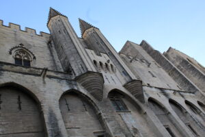 Two towers outside the Palais des Papes with gothic architecture
