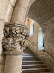 Image of the flourishes on the carved stone on an archway entrance to a stairwell