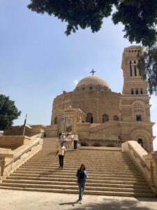 Image of a stairwell leading up to the Hanging Church in the religious square in Old Cairo. The stairs and church are made out of the iconic Egyptian sandstone. 