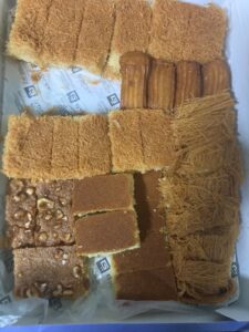 Image of the box of Ramadan desserts that we ended up buying. There are six rows of all different types of pastries.