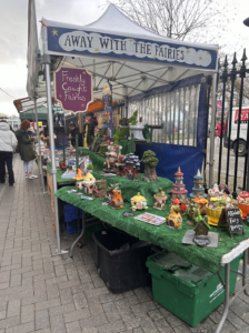 a stall with fairy houses and fake grass
