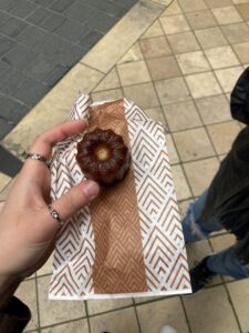 Me holding a Canelé, the pastry of Bordeaux