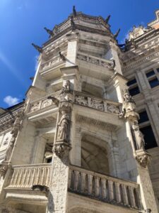 A spiral staircase what was the King's entrance in the Château de Blois. It is made from a white stone and is lined with gargoyles at each level.