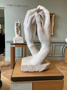 A sculpture of hands by Rodin, wrapping around the wrists and facing each other