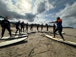 Surfers on surfboards in the sand
