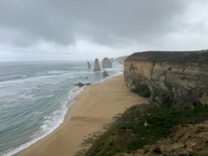Hazy beach with rock towers in water