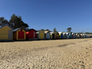 colorfully painted bathing boxes on beach