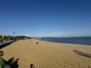 Beach picture of sand and ocean from a boardwalk