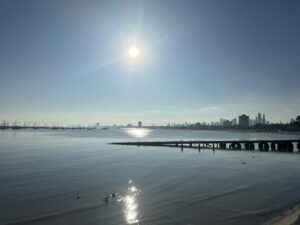 Ocean with pier and sunlight