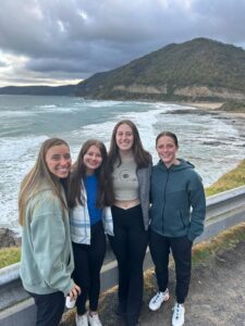 Group of girls posing in front of ocean